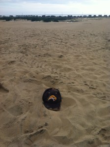 Sabres hat atop sand dune